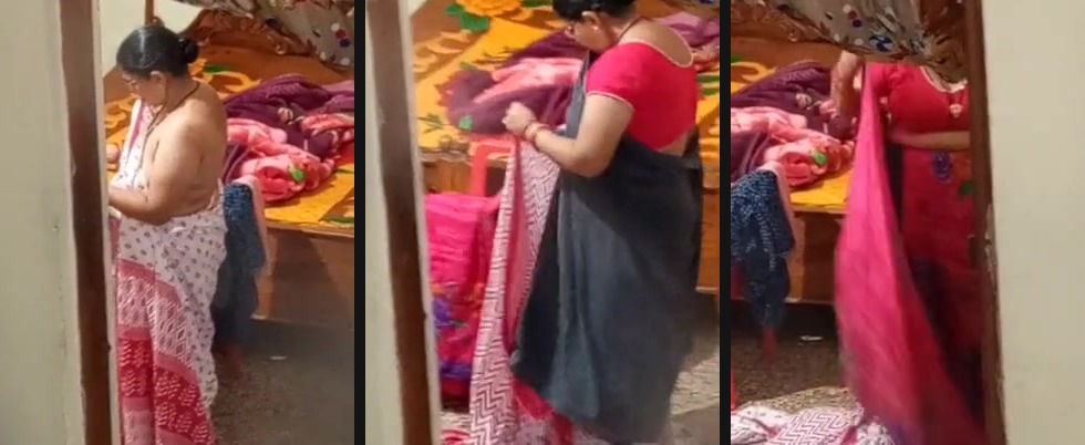 Aunty caught on hidden cam while dressing video | Watch video of aunty caught on hidden cam. Peeping from another room; this guy captures her dressing video to share with his friends.
